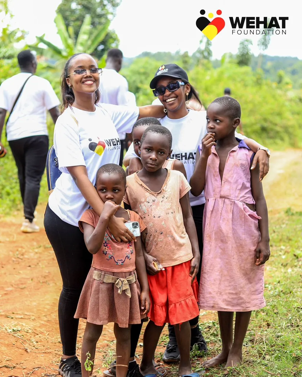 WEHAT Foundation Uganda NGO volunteers with young girls from the community in eastern uganda during christmas outreach 2023